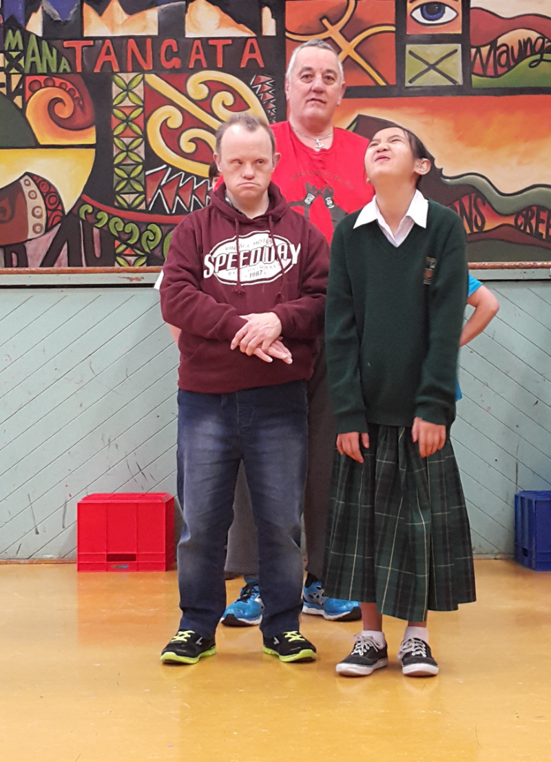 Murray, Michael and Nga perform for the audience of students