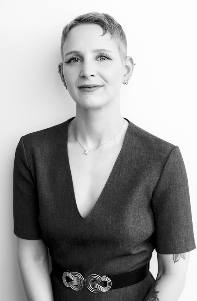 Black and white professional portrait of a woman with short hair against a light background.