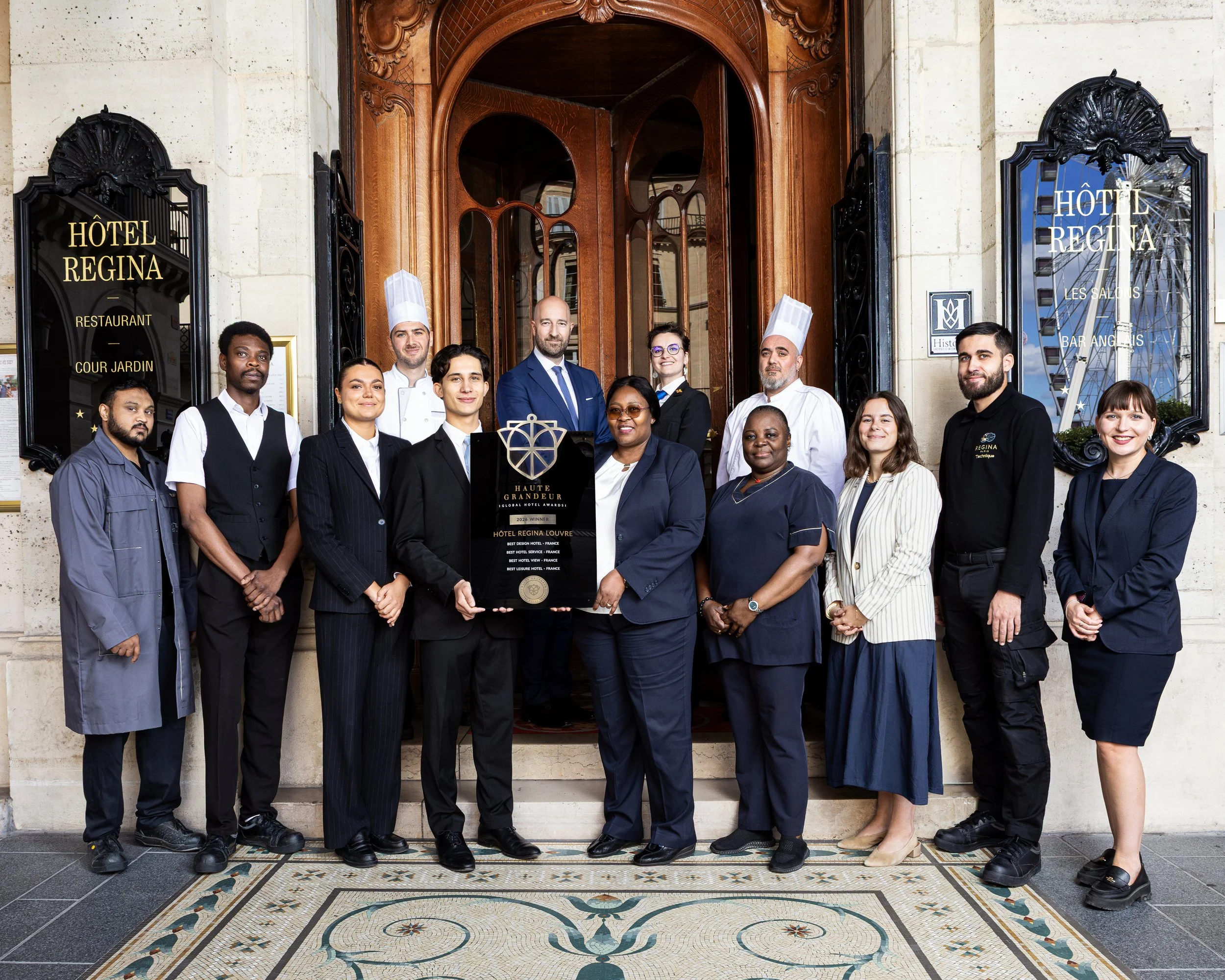 Group portrait of the Hôtel Regina Paris team photographed outside the hotel entrance.