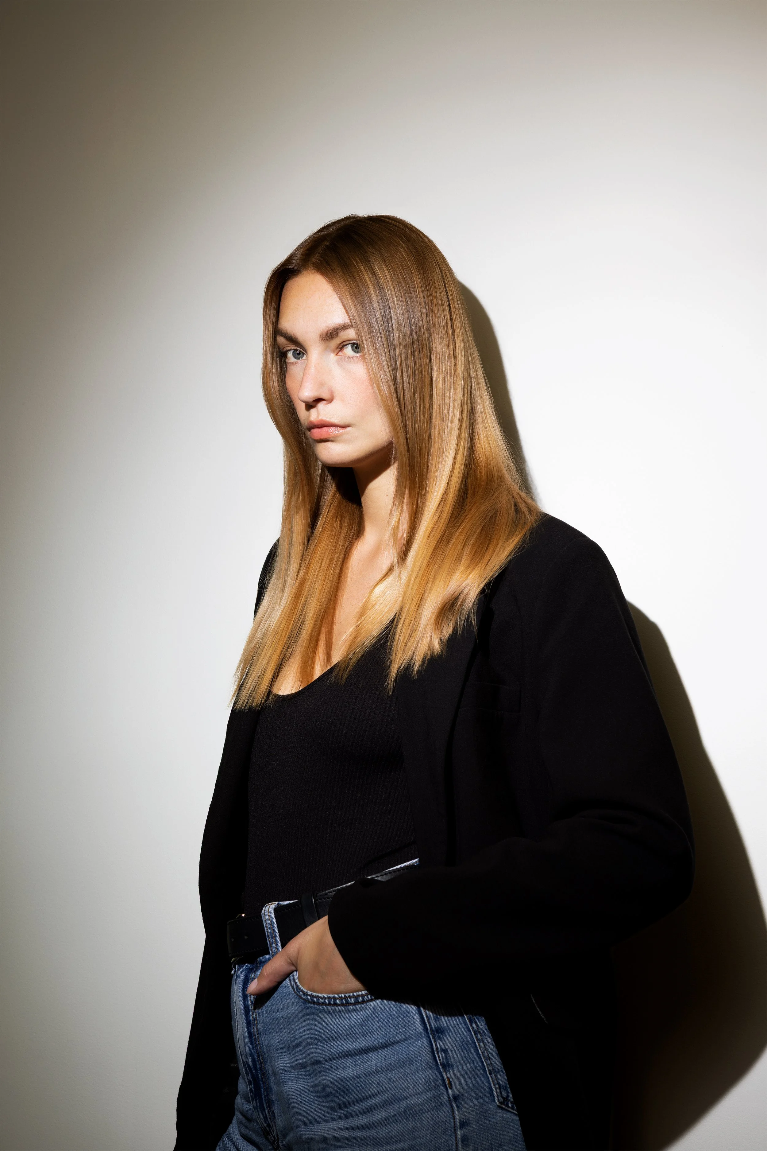 Editorial portrait of a model with sleek straight blonde hair and natural shine.