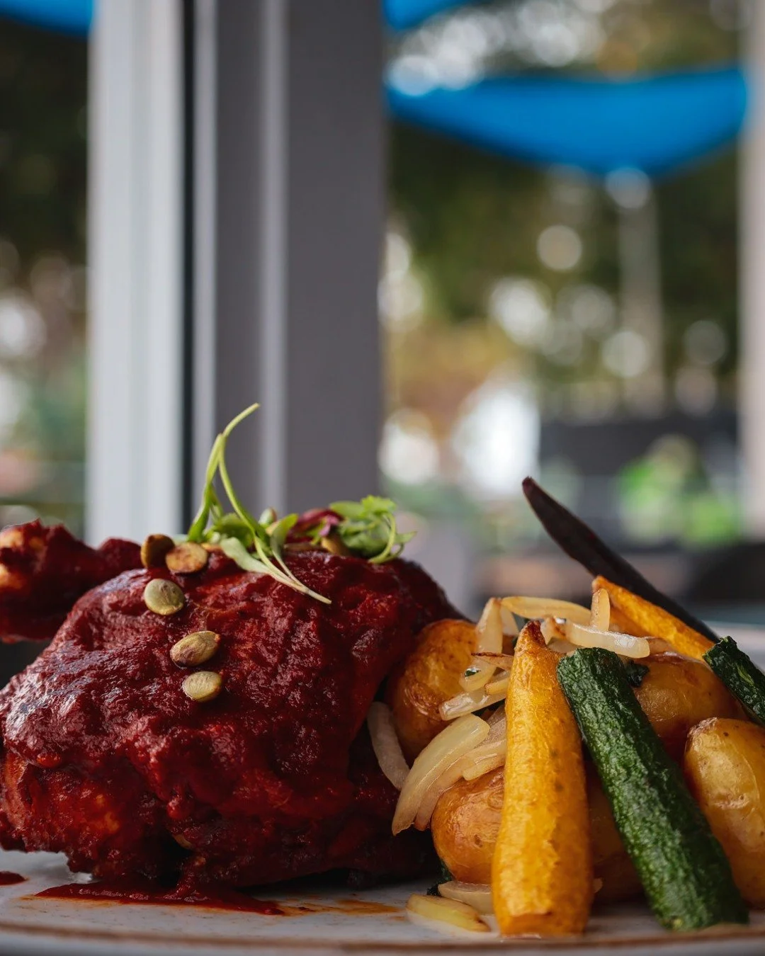 Meet our Pollo Adobado: half chicken marinated in Do&ntilde;a Reyna&rsquo;s Adobo recipe, roasted to perfection, and served with roasted garlic&ndash;epazote potatoes, grilled vegetables, and pepitas. 🍂 Part of our Sabores del Oto&ntilde;o prix fixe