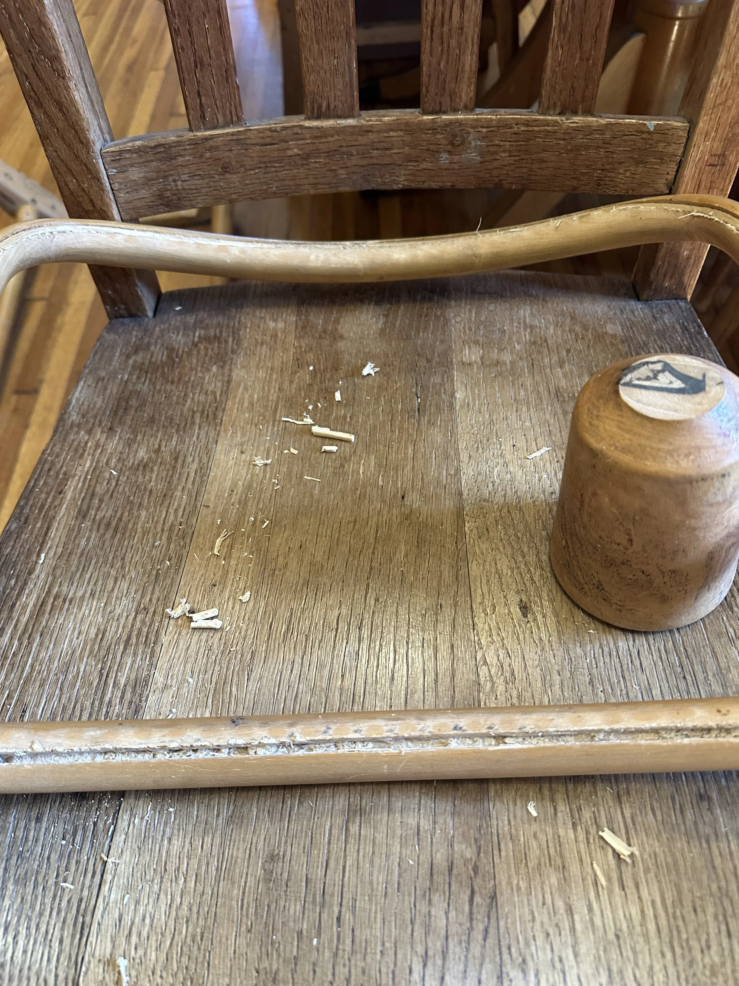 Chair caning project. Image of a cleared cane passage. Ready for new cane. We repaired 8 dining chairs. We Deconstructed the backs and seats, prepared caning material for caning, and performed minimal repairs on the frames and legs.