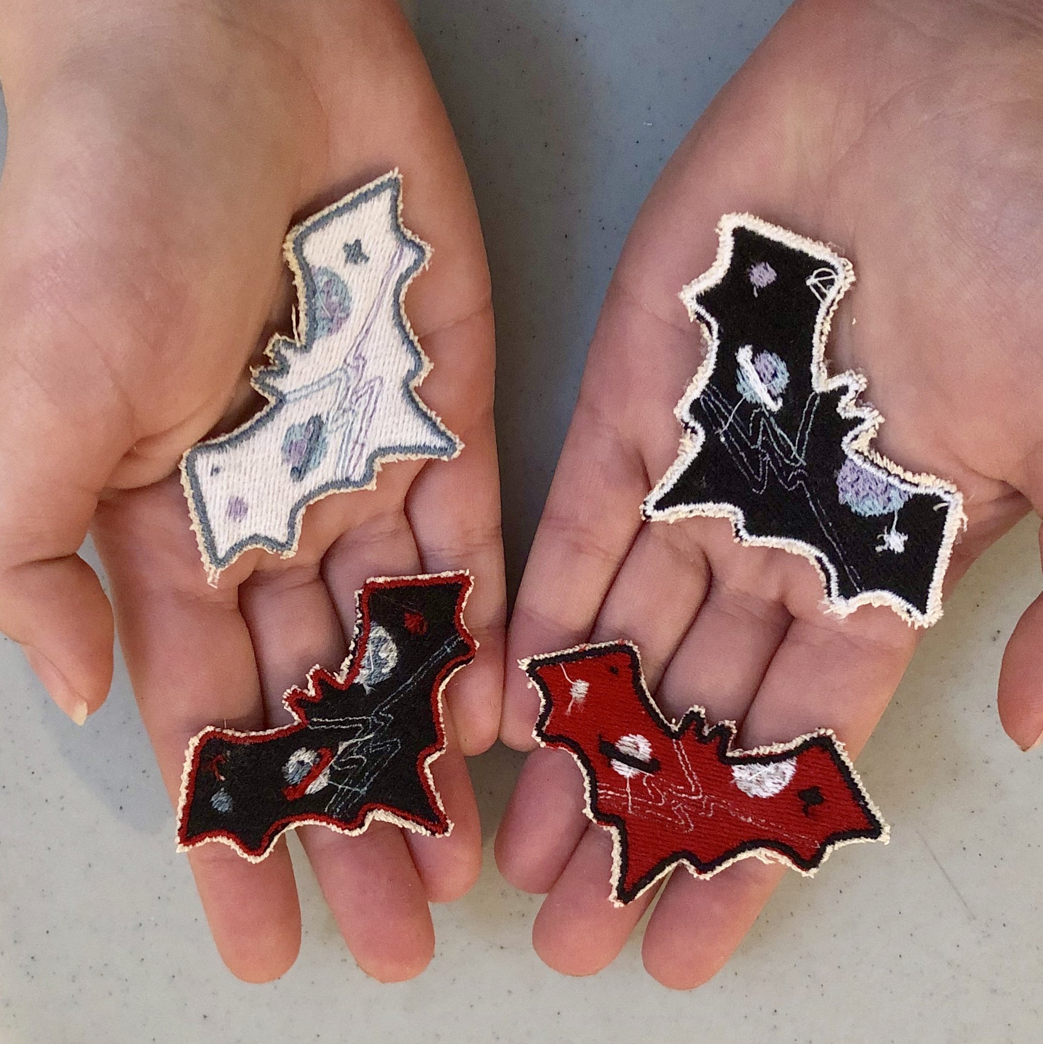 Space Bat Patches. Samples of different color options of machine embroidery bats that were drawn, programmed, and fabricated.