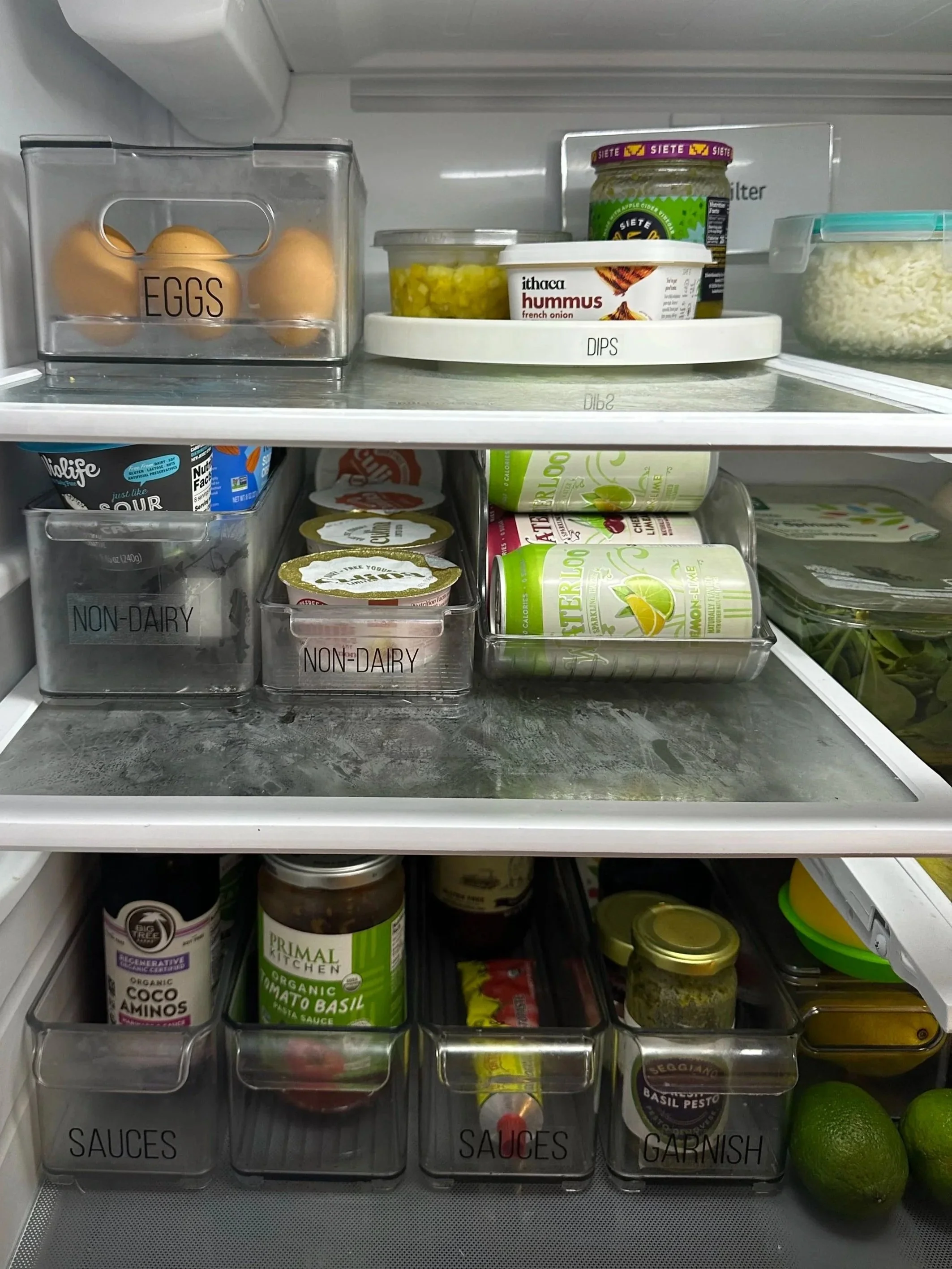 Refrigerator with food sorted into bins