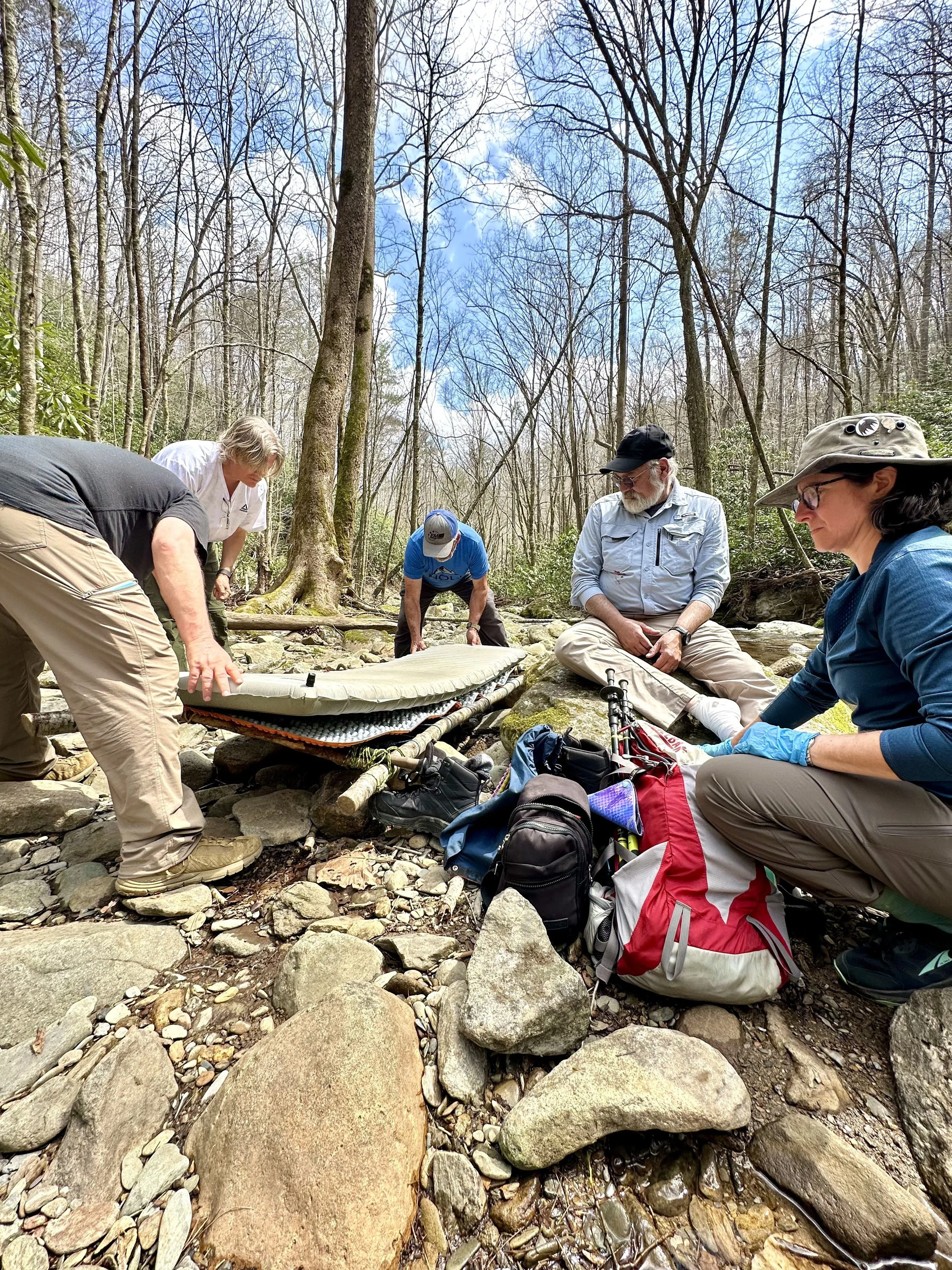 Wilderness First Responder Training. Moving an injured patient with an improvised litter.