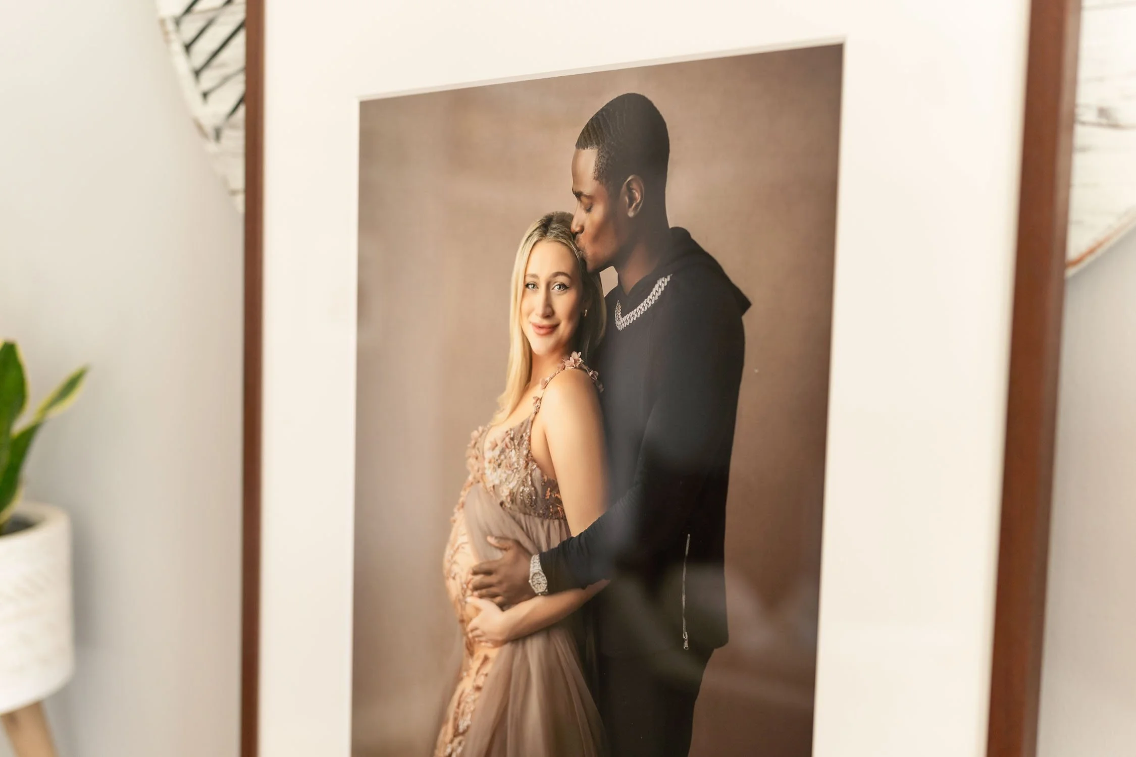 Close up of a framed maternity portrait of an expecting couple.