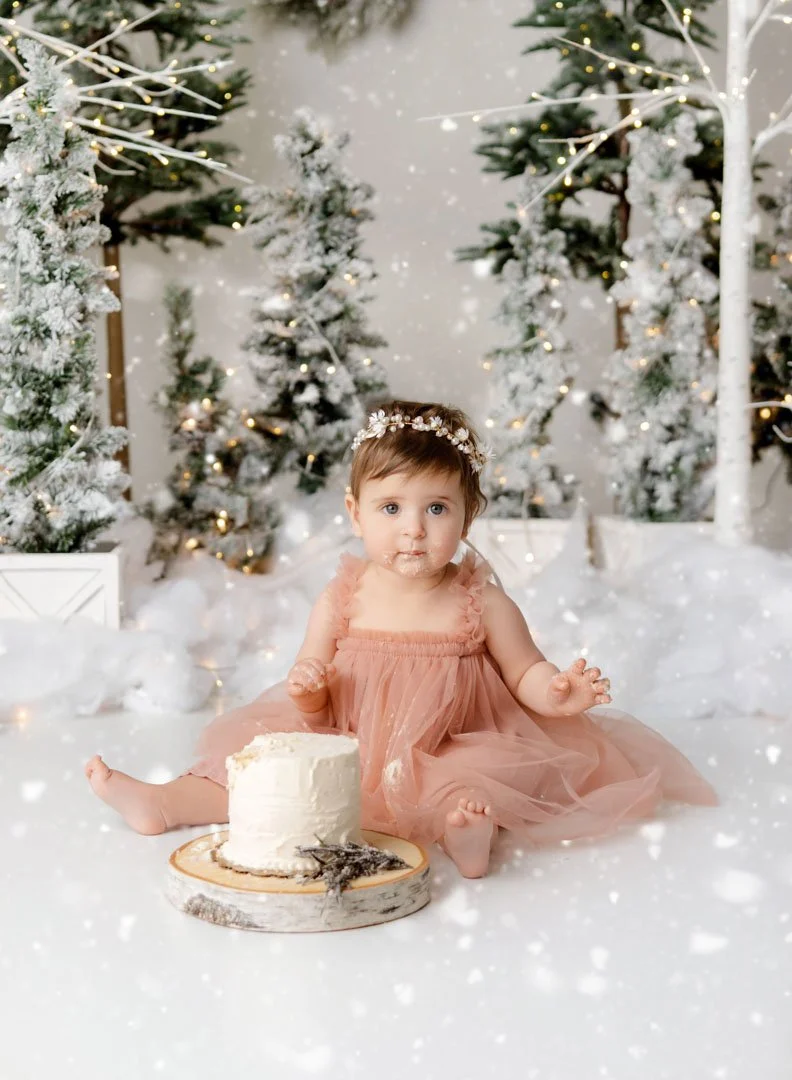 Cake smash pictures of a baby's first birthday at a local photography studio.
