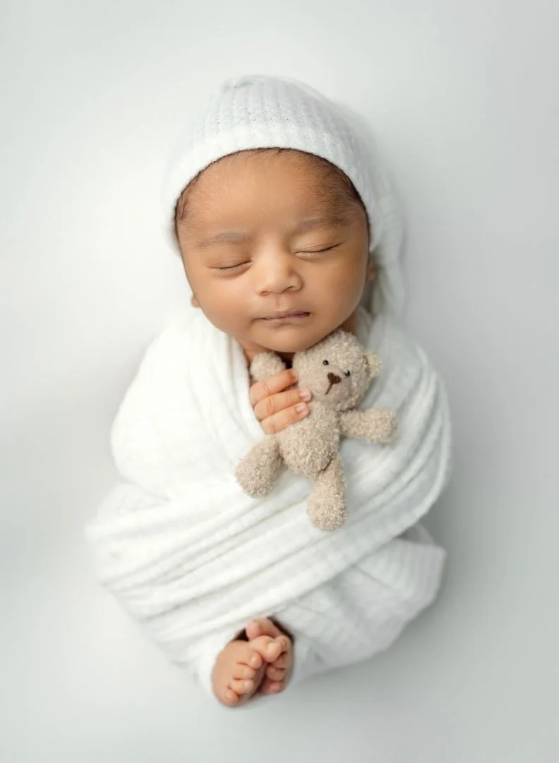 newborn boy in white for studio session by st louis newborn photographer