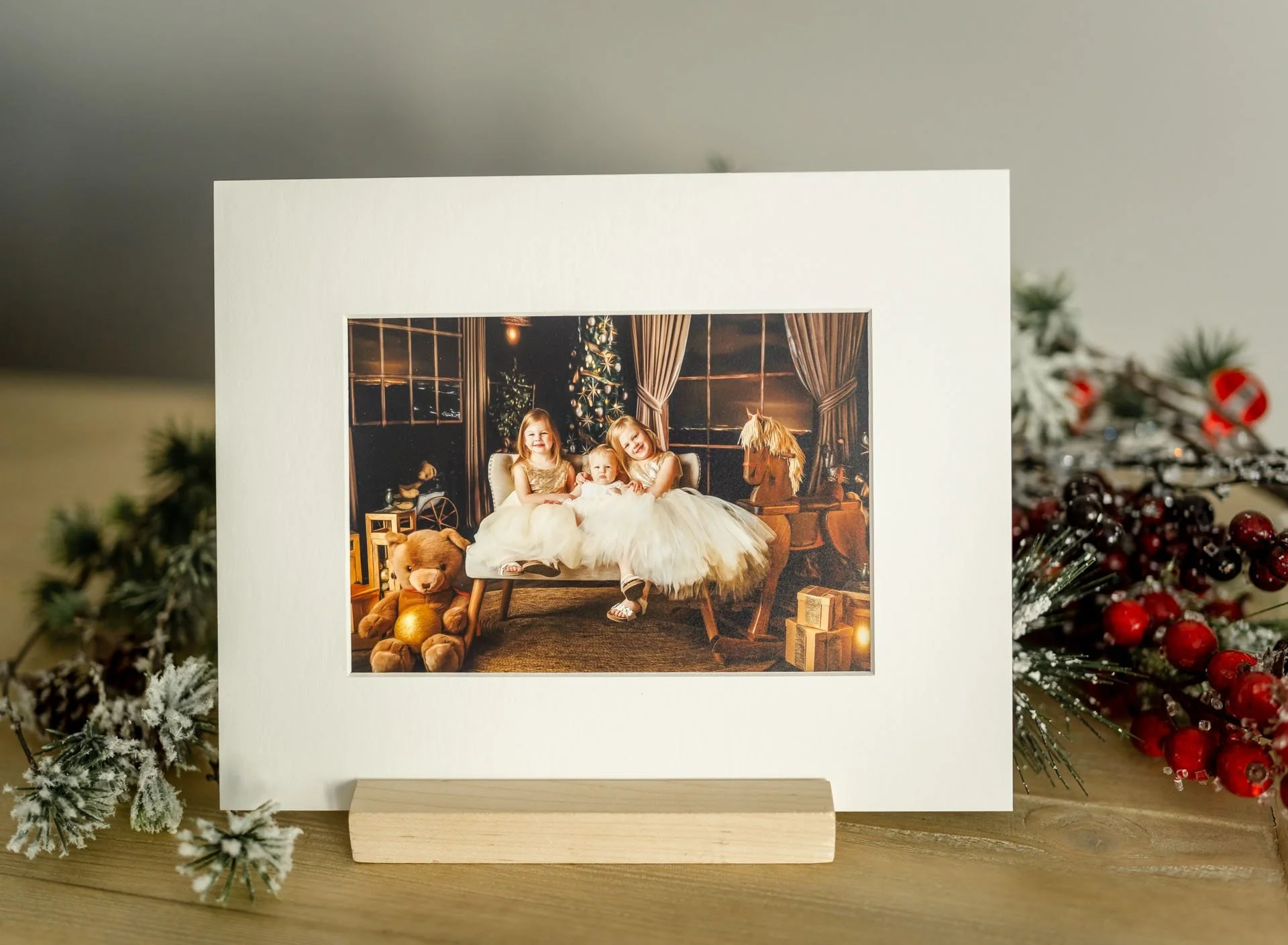 matted holiday portrait displayed as finished holiday artwork with festive greenery.