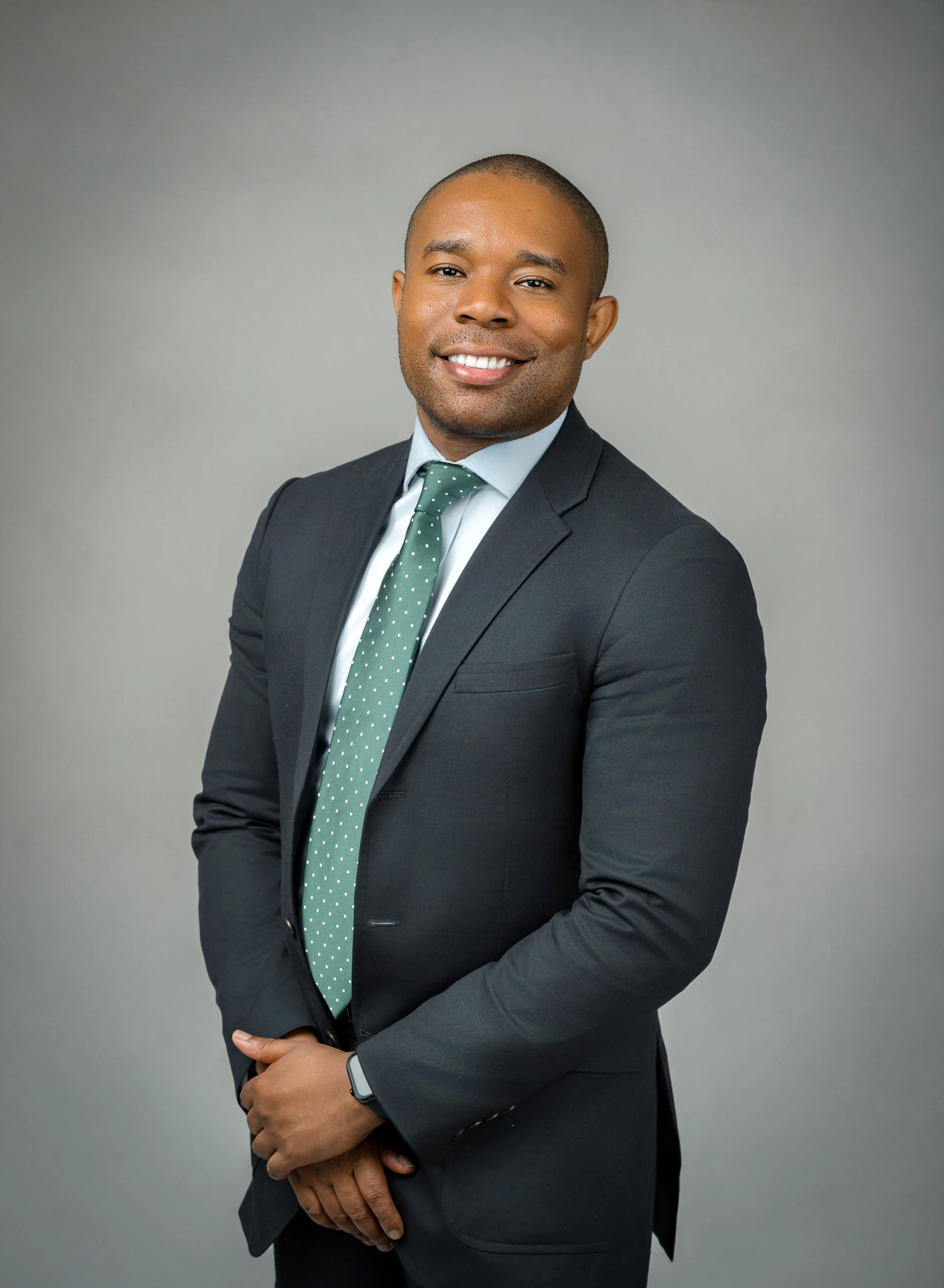 Professional headshot taken at a local indoor photography studio.