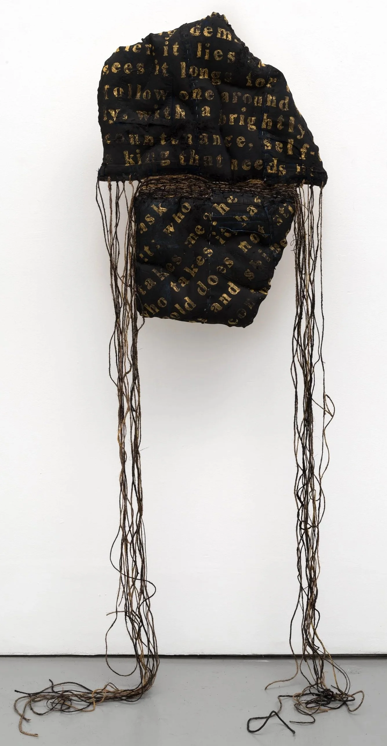 Joy Ray|ask it: who takes me|2025|Thrift store denim, twine, fabric, paint; text from The Red Book by Carl Jung|35x25x3 Inches