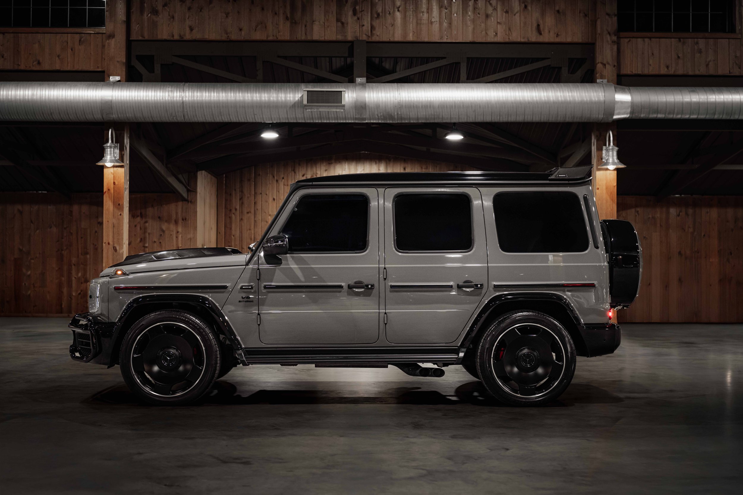 Side Profile in Wooden Garage
Side profile of the G63 ‘Stronger Than Time’ edition against a wooden garage backdrop, highlighting its boxy silhouette and premium wheels.