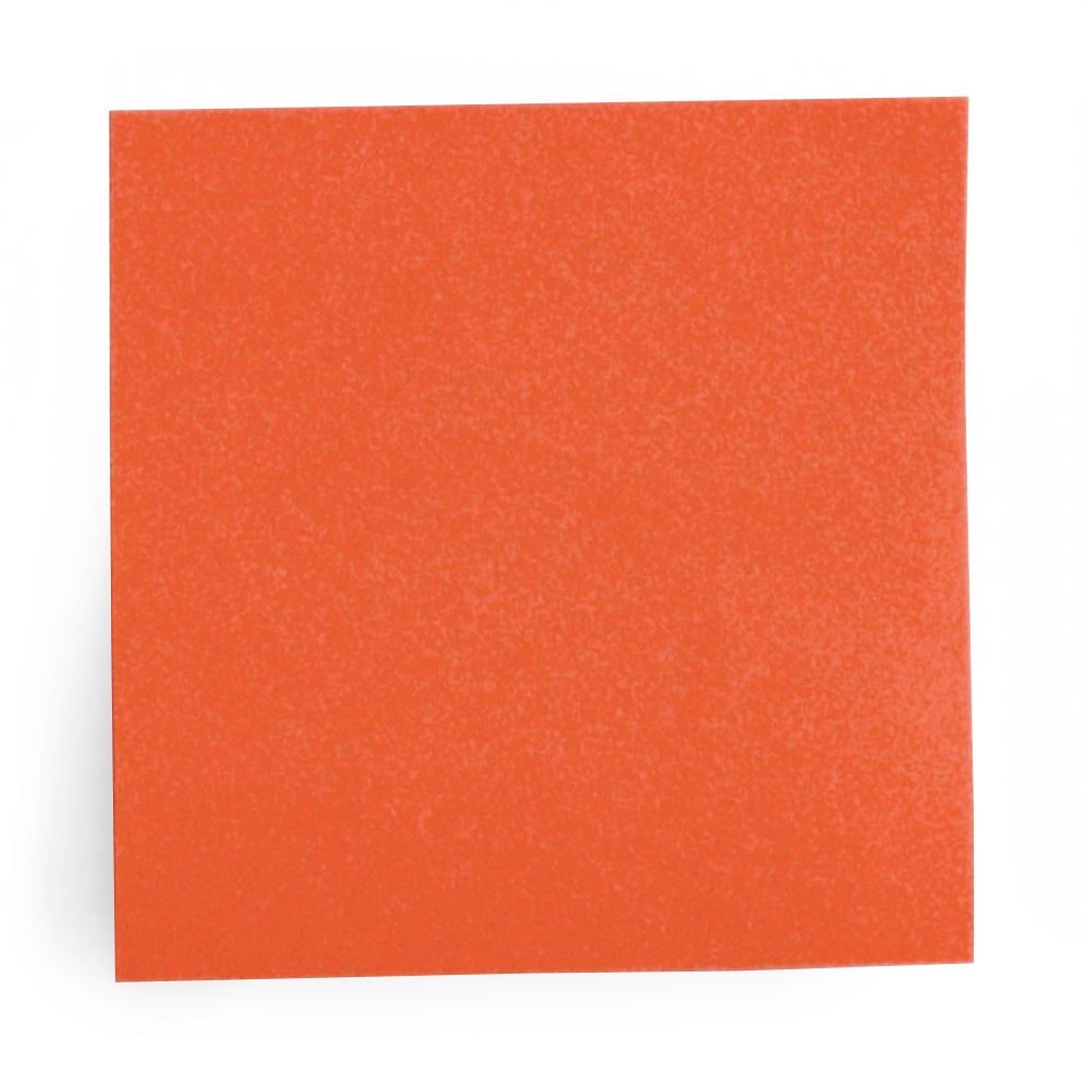 Close-up of a bright orange foam sponge resting on a white surface.