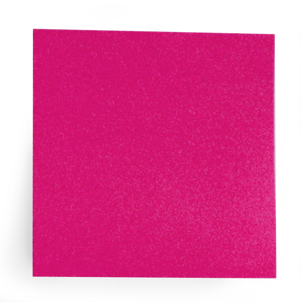 Close-up of a pink foam sponge with a textured surface, standing on a dark surface with a blurred green background.