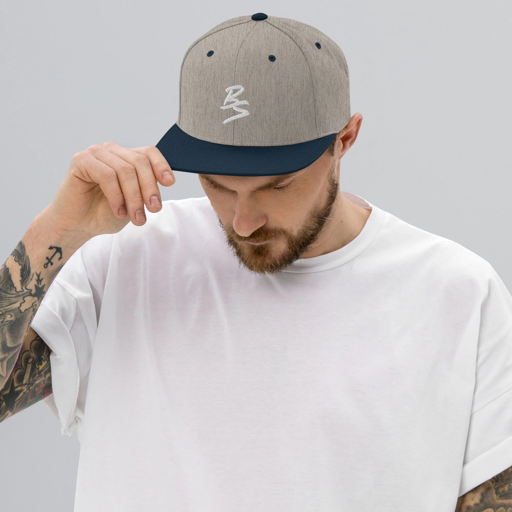 classic-snapback-heather-grey-navy-front-65a4331a733c6.jpg