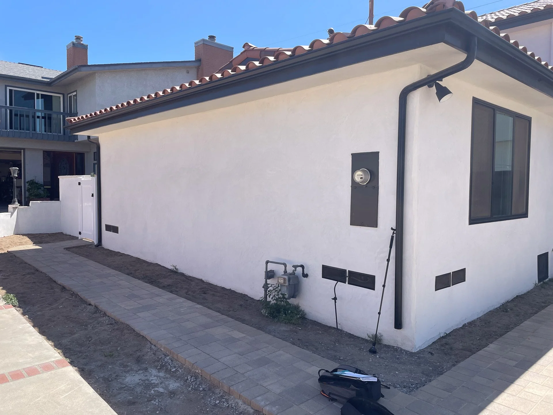 Before Installation: The client was unsure what to do with two strips, 3' wide, between the house and a path, and a path and an adjacent driveway. Luckily we knew exactly what you could do with that much space.
