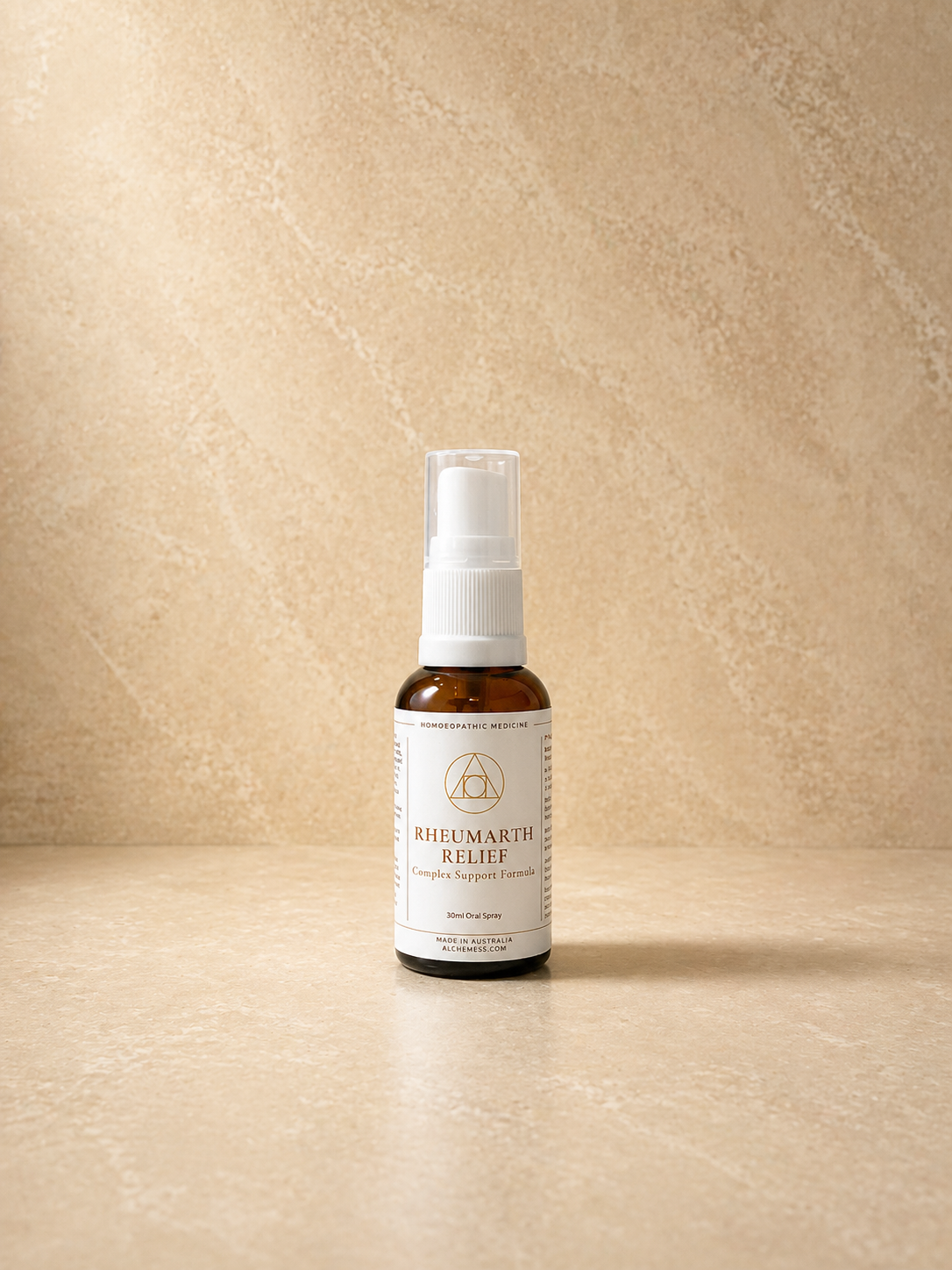A small amber glass dropper bottle with a black cap and dropper, labeled 'Alchemy{ess} Support Essence RheumArth Relief' against a plain white background.