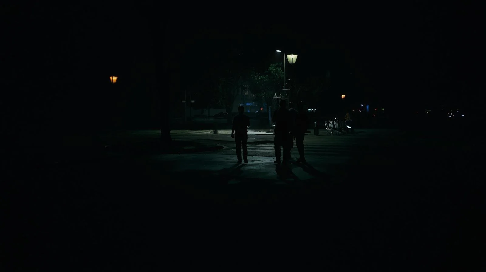 men silhouettes in public in the dark - public space