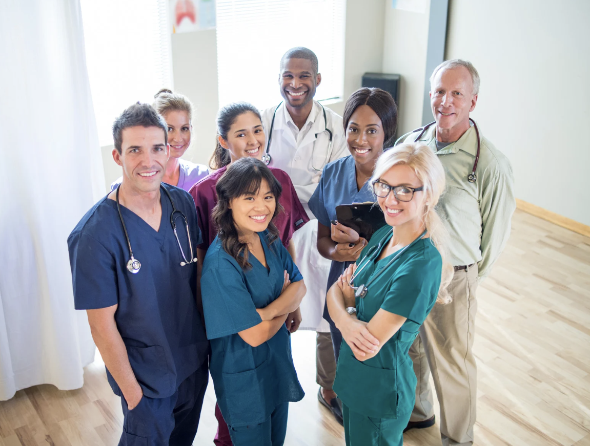 Healthcare professionals standing together in a clinical setting — reflecting employers’ responsibilities under the Worker Protection Act to ensure respect, safety and prevention of workplace harassment.