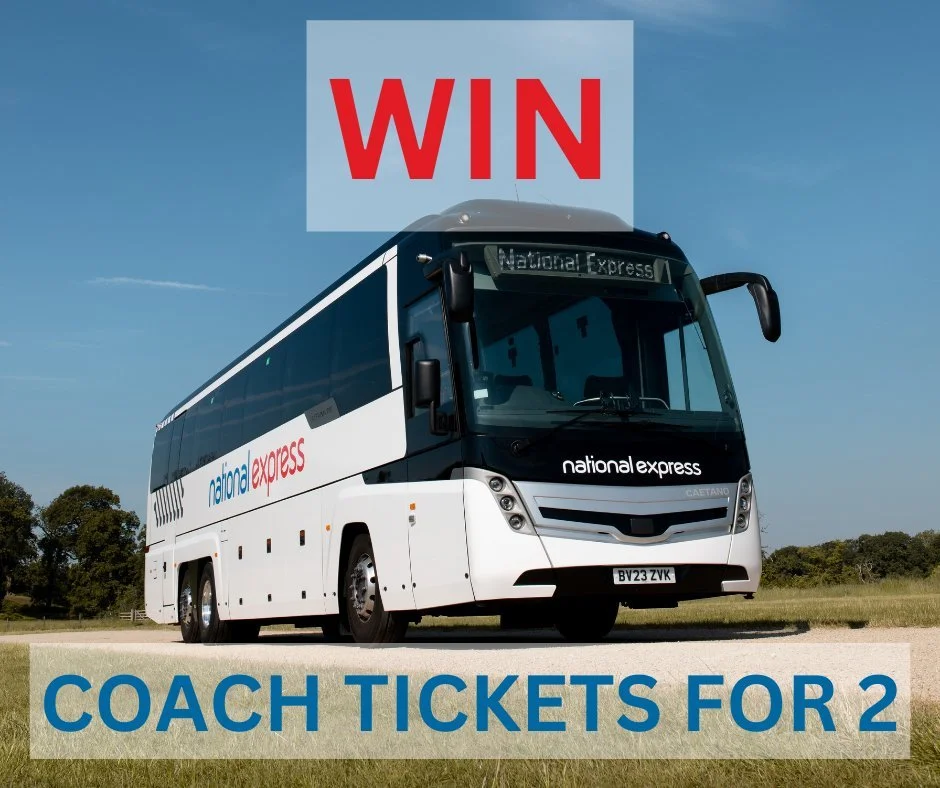 A white coach bus with 'national express' branding parked on a grassy area under a blue sky, with a red and white sign above it that reads 'WIN'. The bottom text says 'COACH TICKETS FOR 2' in blue letters.