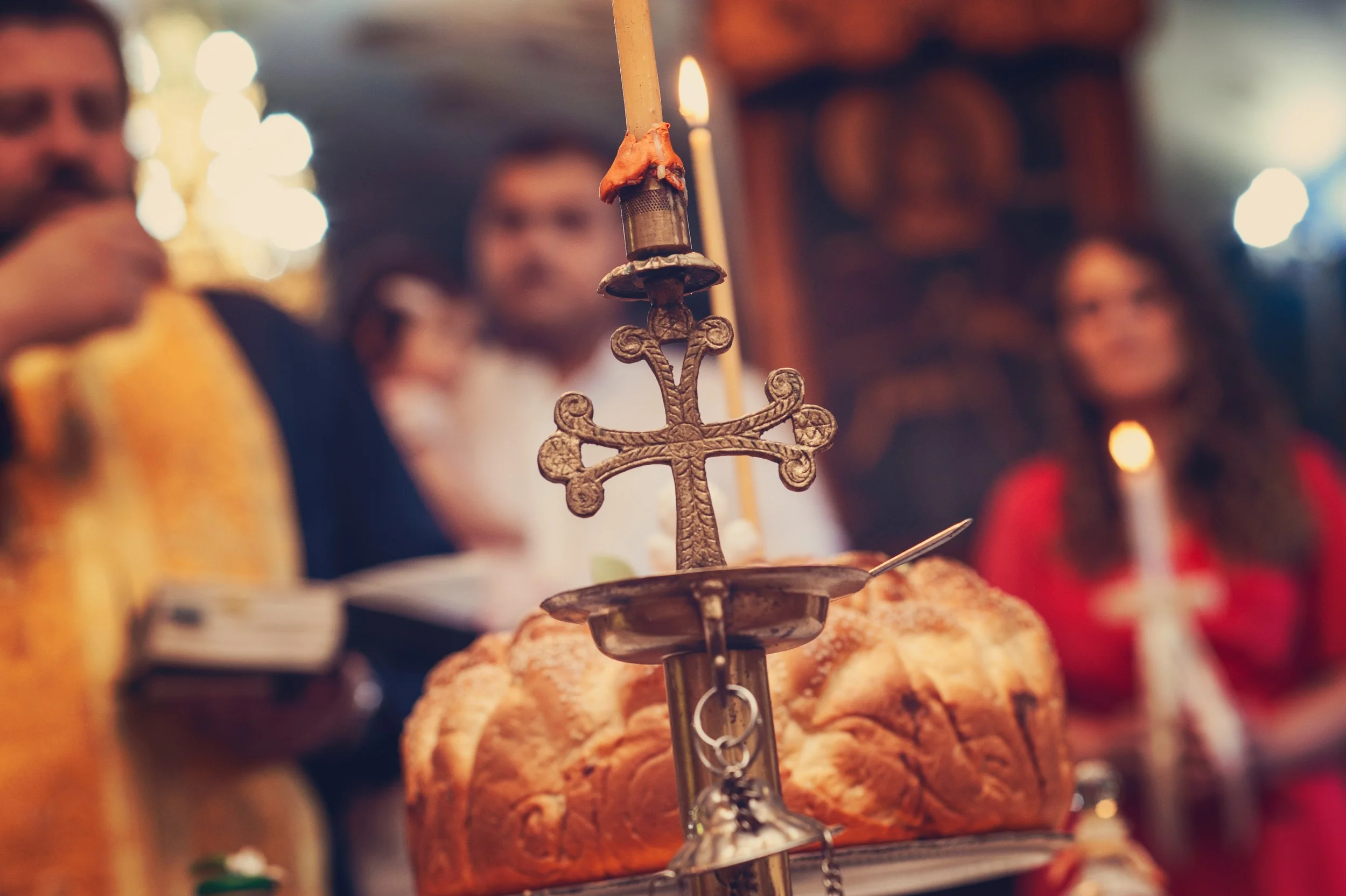 Religious ceremony with candle, cross, and bread