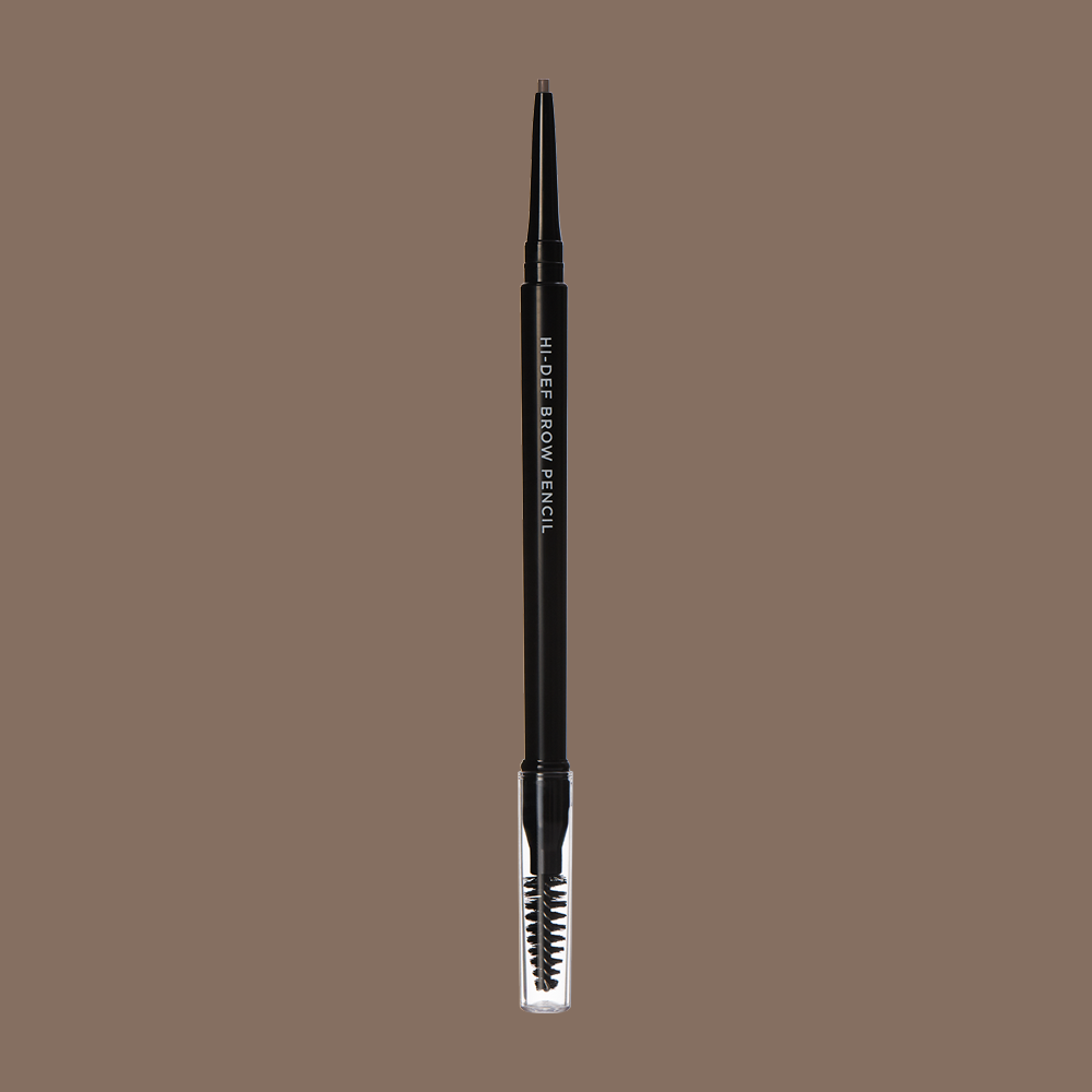A black eyebrow pencil with a clear plastic cap against a beige background.