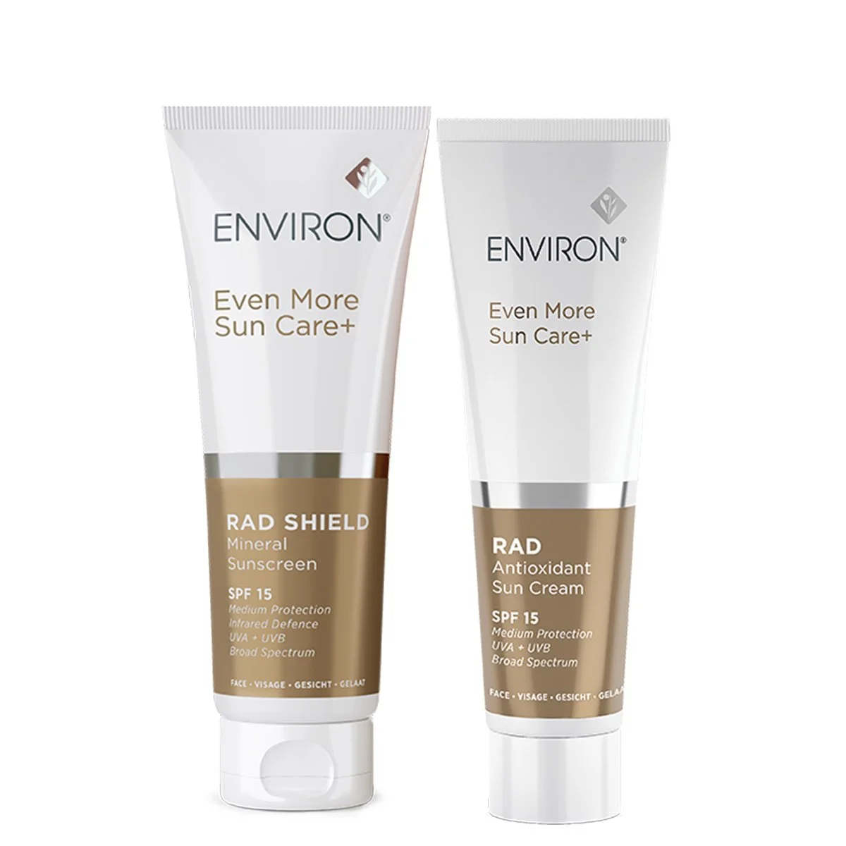 Two tubes of Environ sun care products, one labeled Radiance Shield Mineral Sunscreen SPF 15 and the other Radiance Antioxidant Sun Cream SPF 15, both in white and beige packaging.