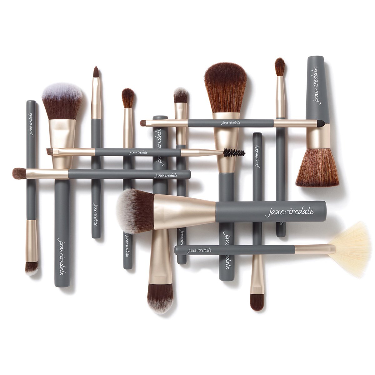 Collection of makeup brushes with gray handles and beige ferrules on a white background.