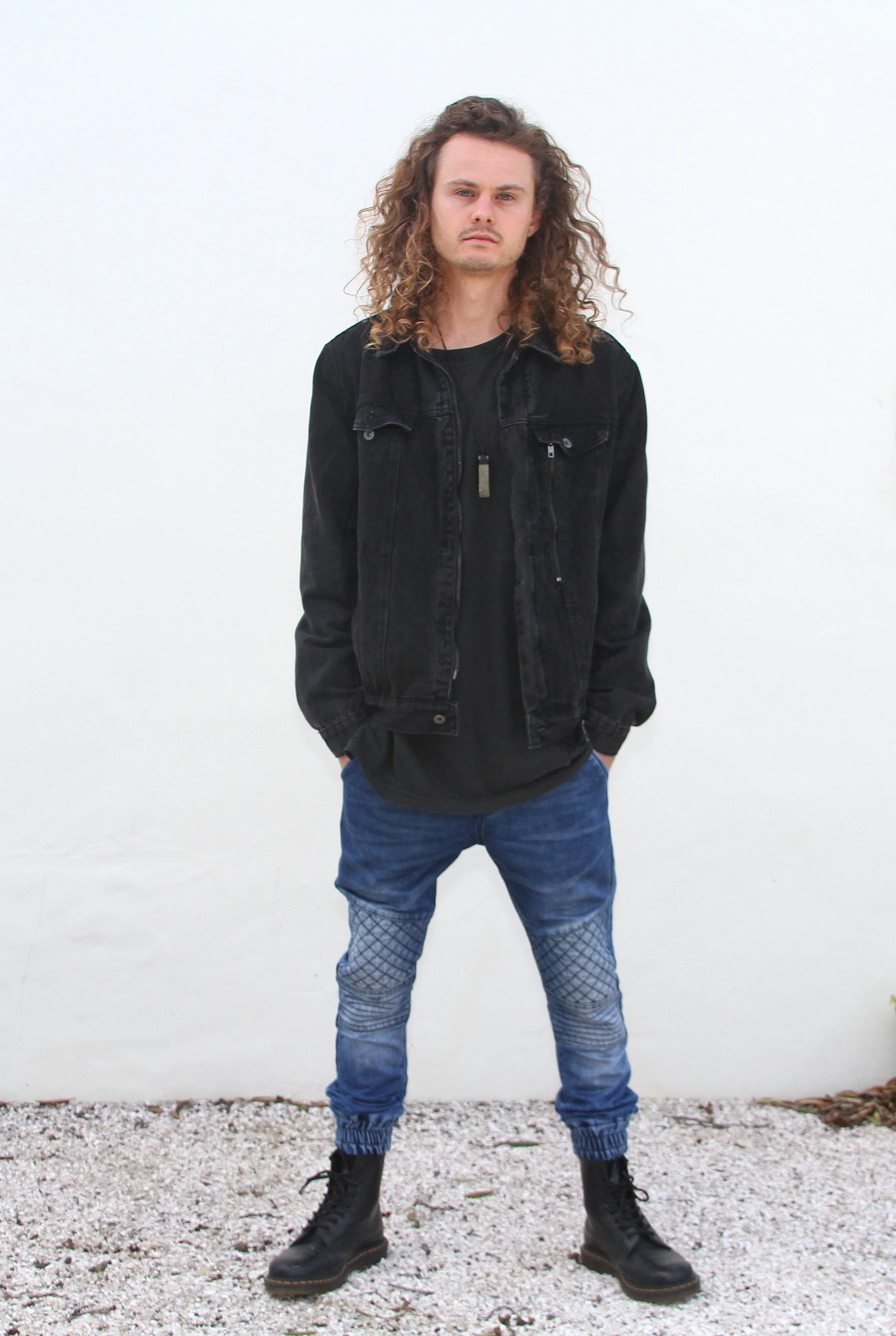 Bass music DJ Ashez poses in preparation for a 404 Productions live event performance.