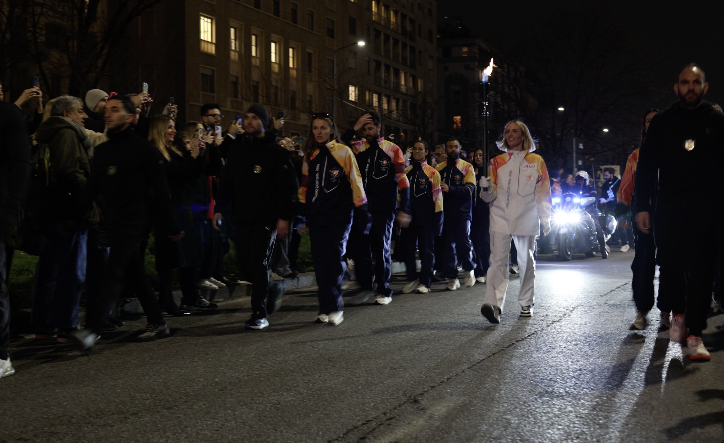 The Olympic flame travels through Milan