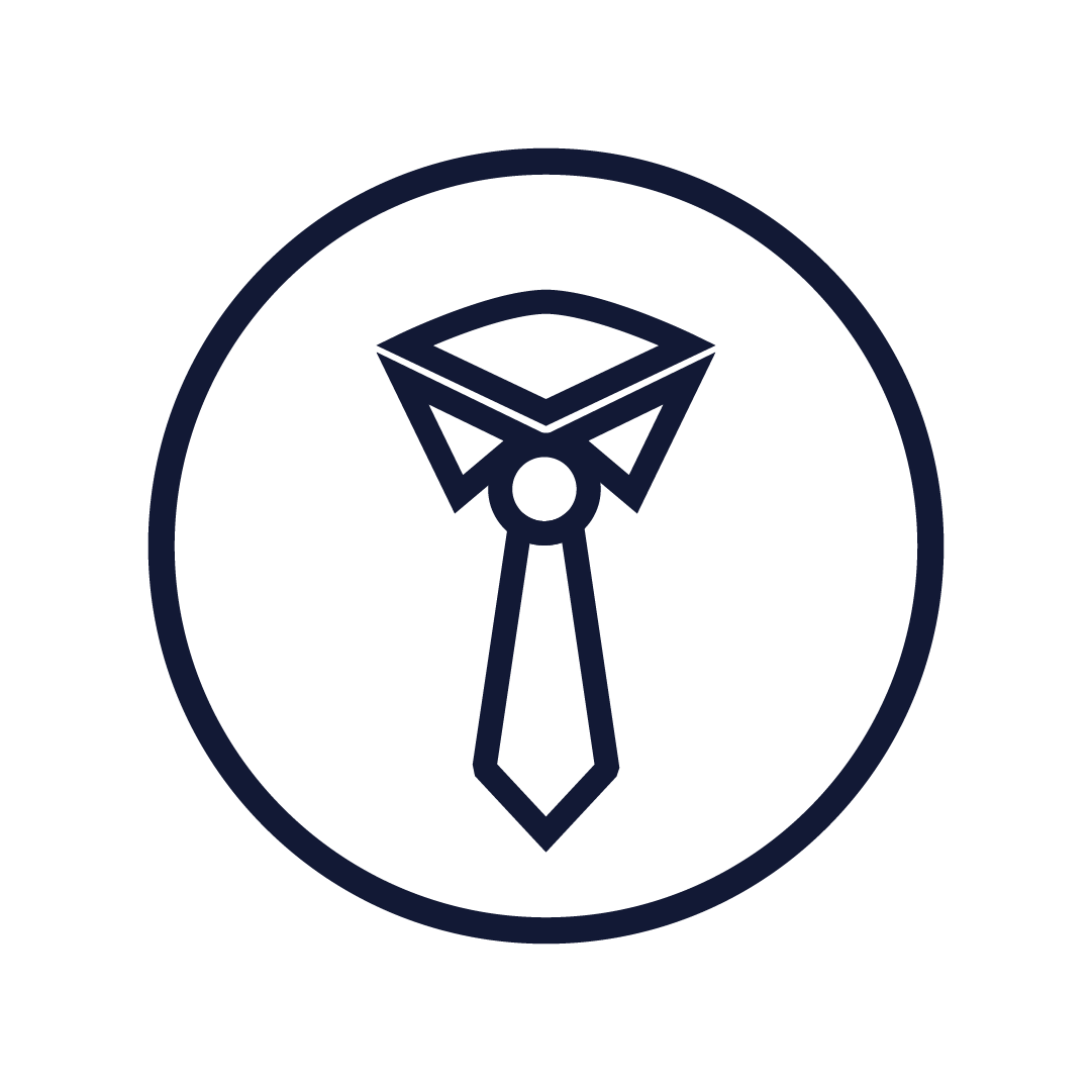 Smiling woman with black hair wearing a blue top in a greenhouse surrounded by green plants.