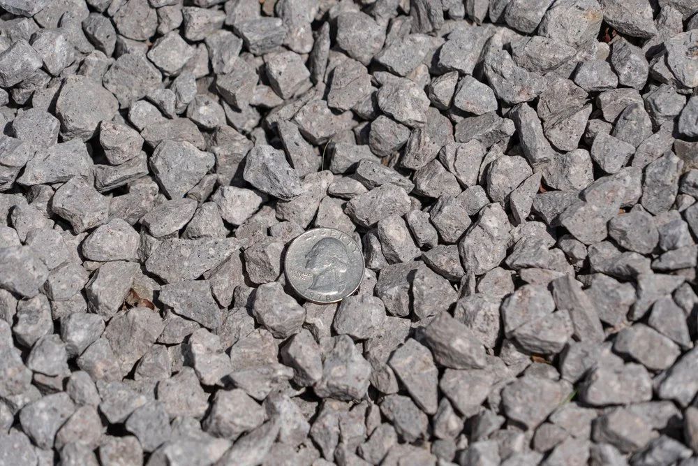 Small, quarter sized grey colored rocks making up an option for landscaping, available at Garden Center of Las Cruces. 