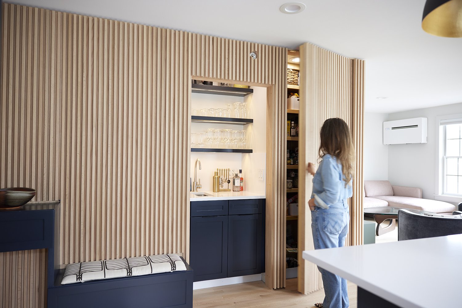 Kitchen Wall After: Covered the wall in wood slats. Turned the w/d closet into a wet bar and coffee station. Kept the pantry but created a hidden door within the slatted wall. Our favorite feature of the renovation!