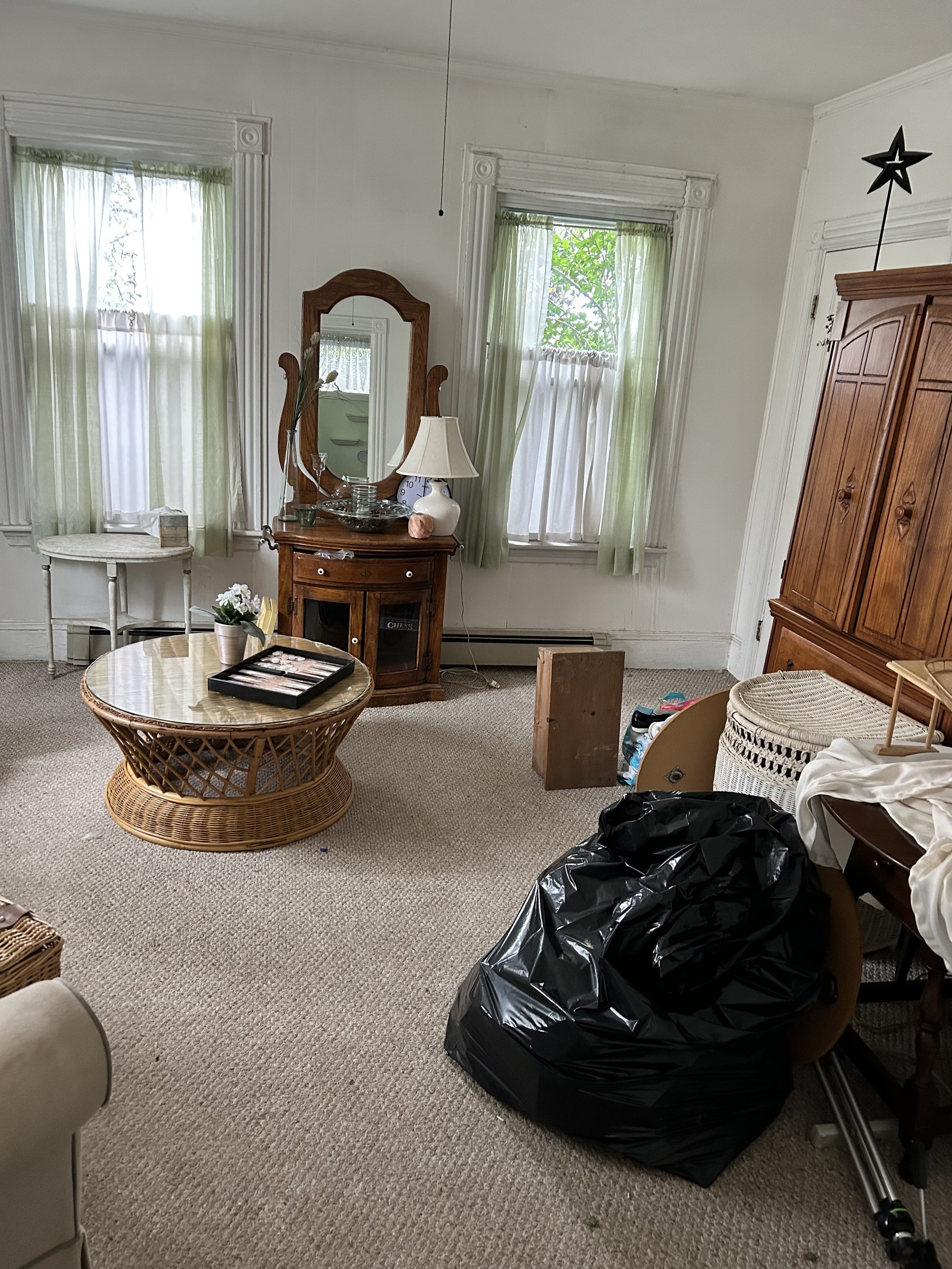Living Room Before: A lot of furniture and bags of belongings cluttered this space.