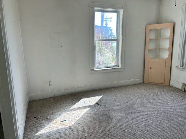 Living Room After: A few remaining furniture pieces awaiting pick-up by a local charity.