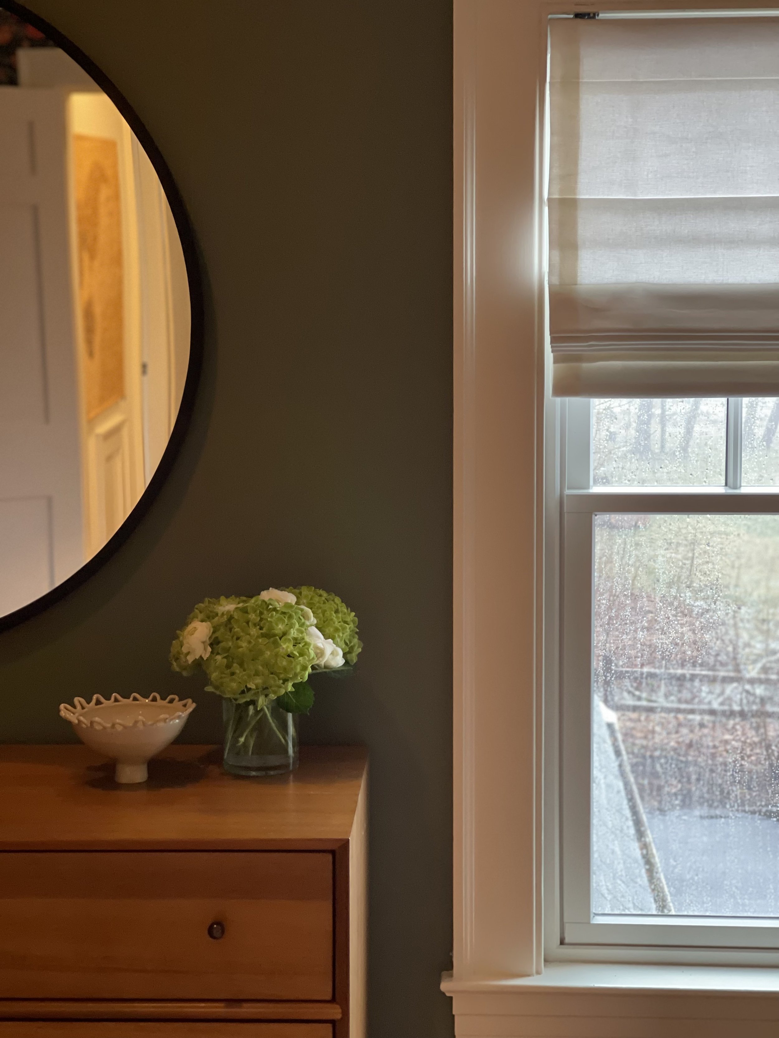 We painted the walls a lush green color to pull in the existing accent wall and was perfect with the incredible light in the room.