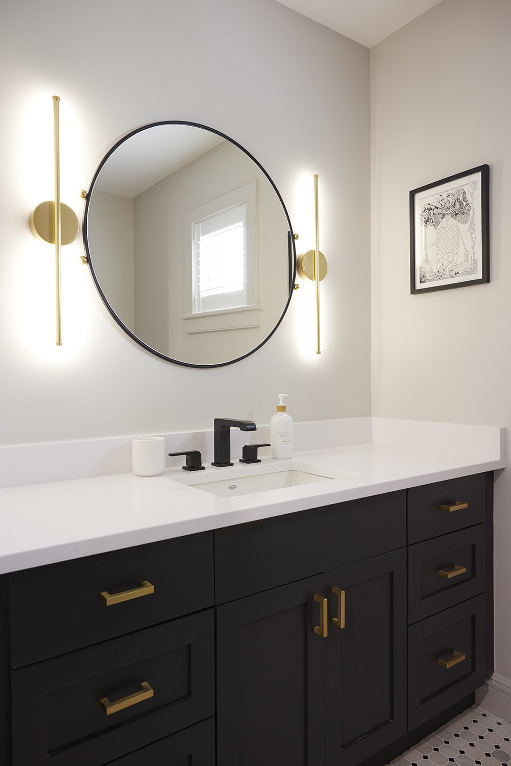 Guest Bathroom After: Painted existing vanity and added new hardware. Added new countertop and sink. Removed giant mirror and replaced it with a smaller, more interesting mirror and sconces that light from the sides rather than above.