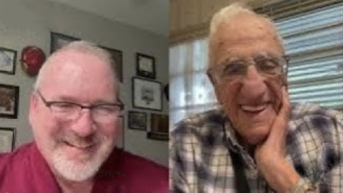 Colorful bouquet of flowers in a white vase on a wooden surface