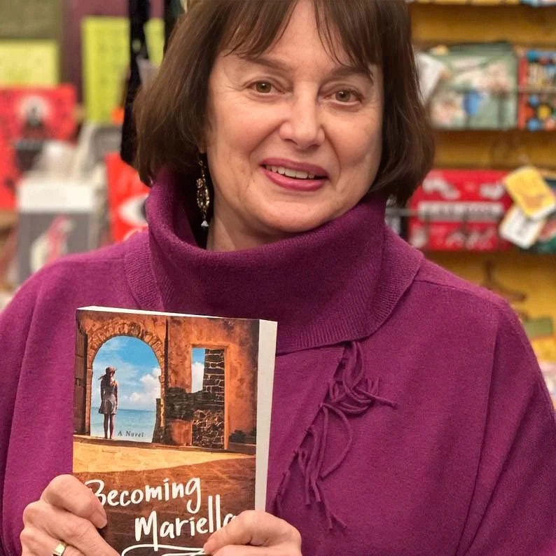 Janet Constantino, holding her book Becoming Mariella