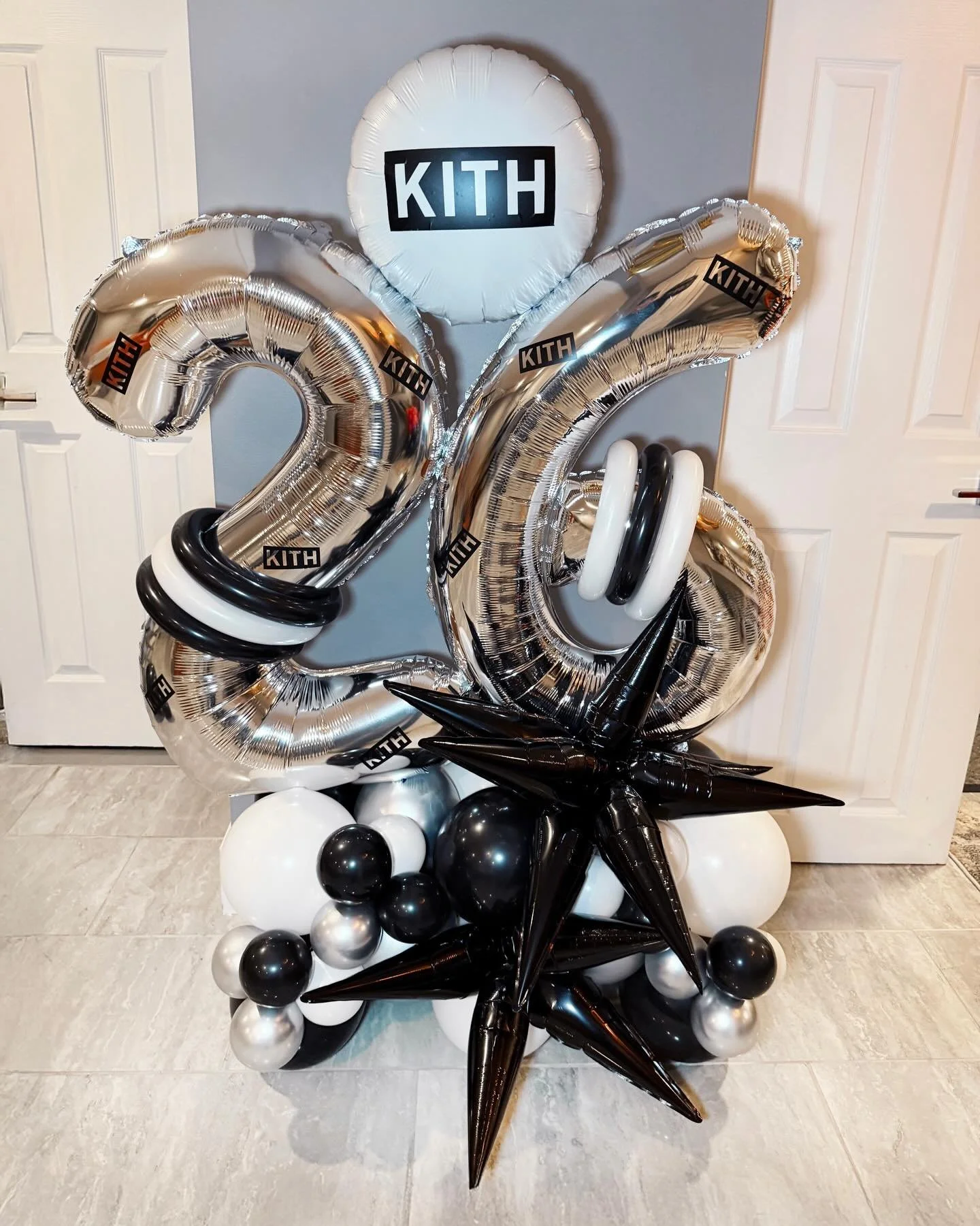 26, but make it KITH-coded.

Chrome numbers, black and white details, and that bold statement balloon bomb to bring it all together. Clean, elevated, and made to stand out.

Perfect for at-home celebrations that still feel like a full moment.