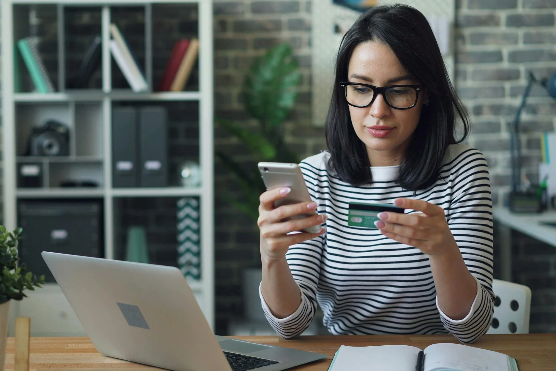 Freelance business owner managing transaction review using mobile app, by Silverkblack at https://www.pexels.com/@silverkblack