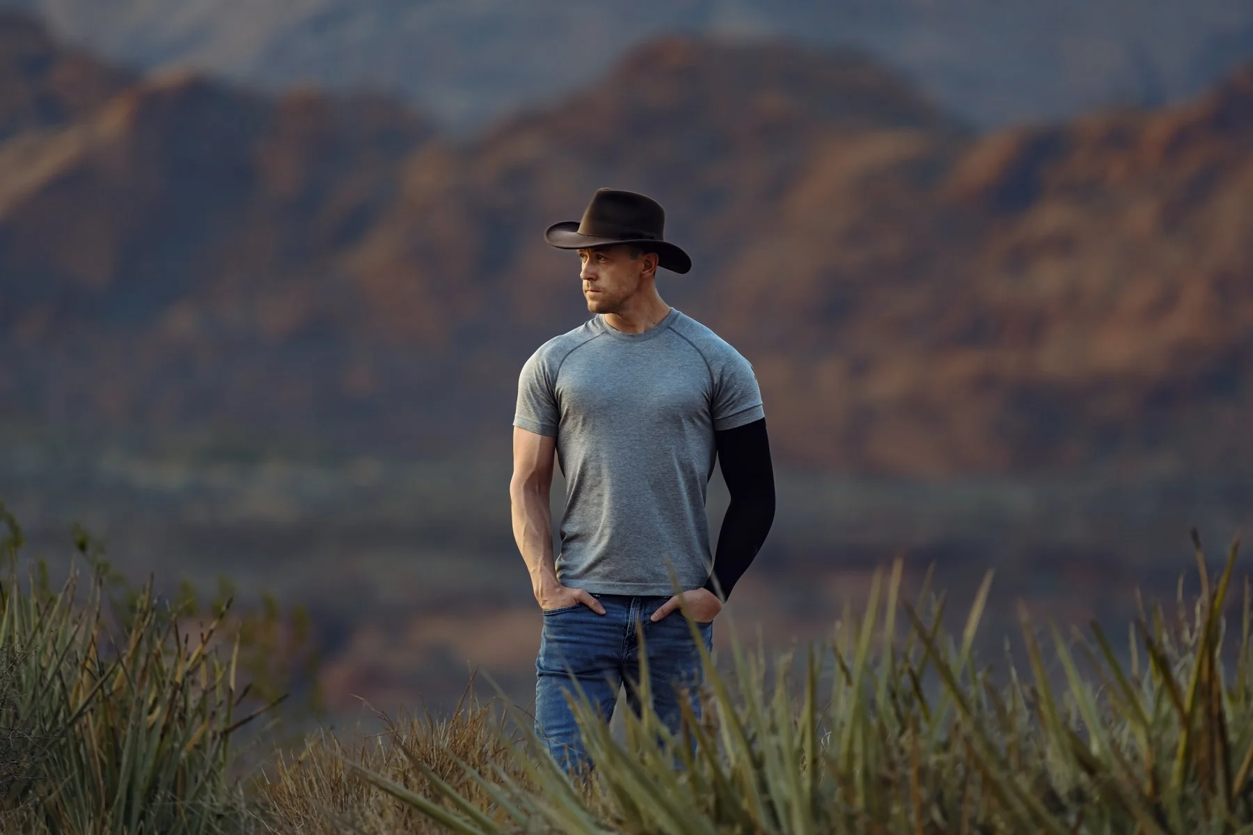North Peak Services Utah bookkeeping team member standing in southern Utah desert with red rock mountains at golden hour. Photo by Rex Jones