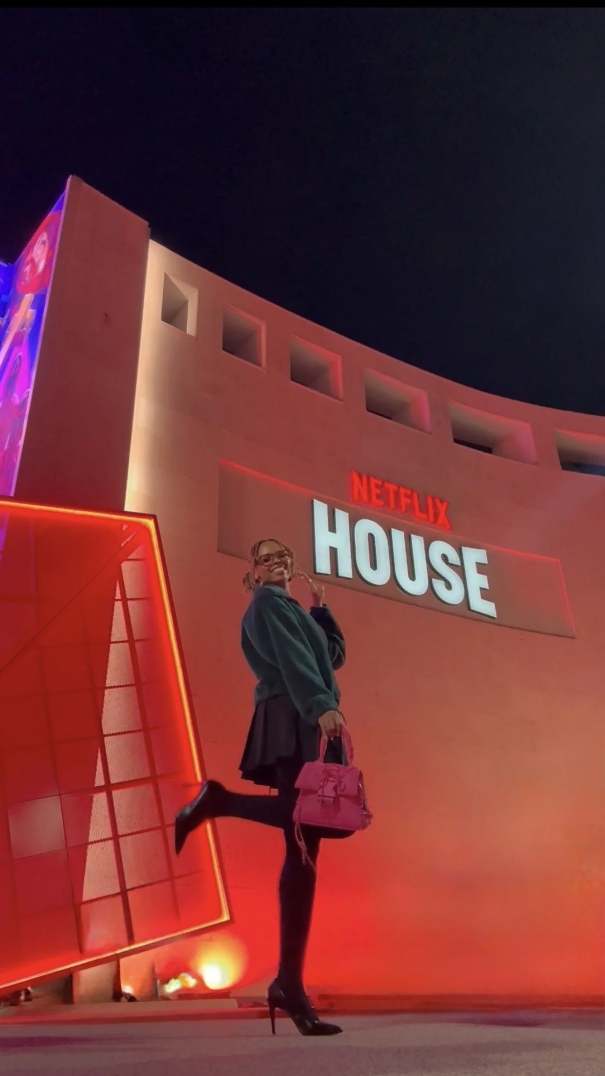 Girl standing in front of new attraction in Dallas- Netflix House.
