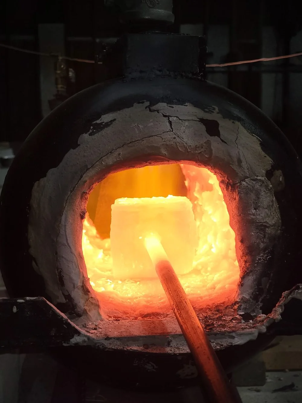 Inside the gas forge, a billet glowing