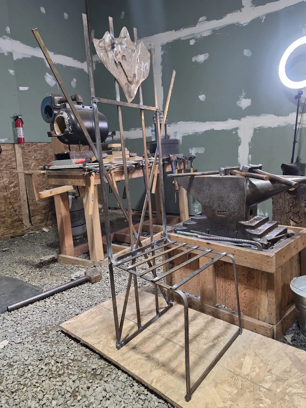 The shop floor with the big anvil and a forged chair frame