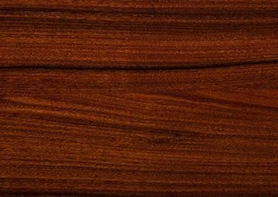 Close-up view of a dark brown wooden texture with visible grain patterns.