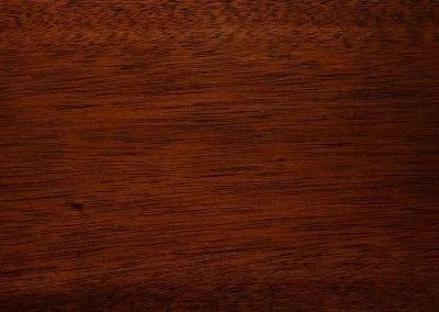 Close-up of dark wood texture with visible grain patterns.