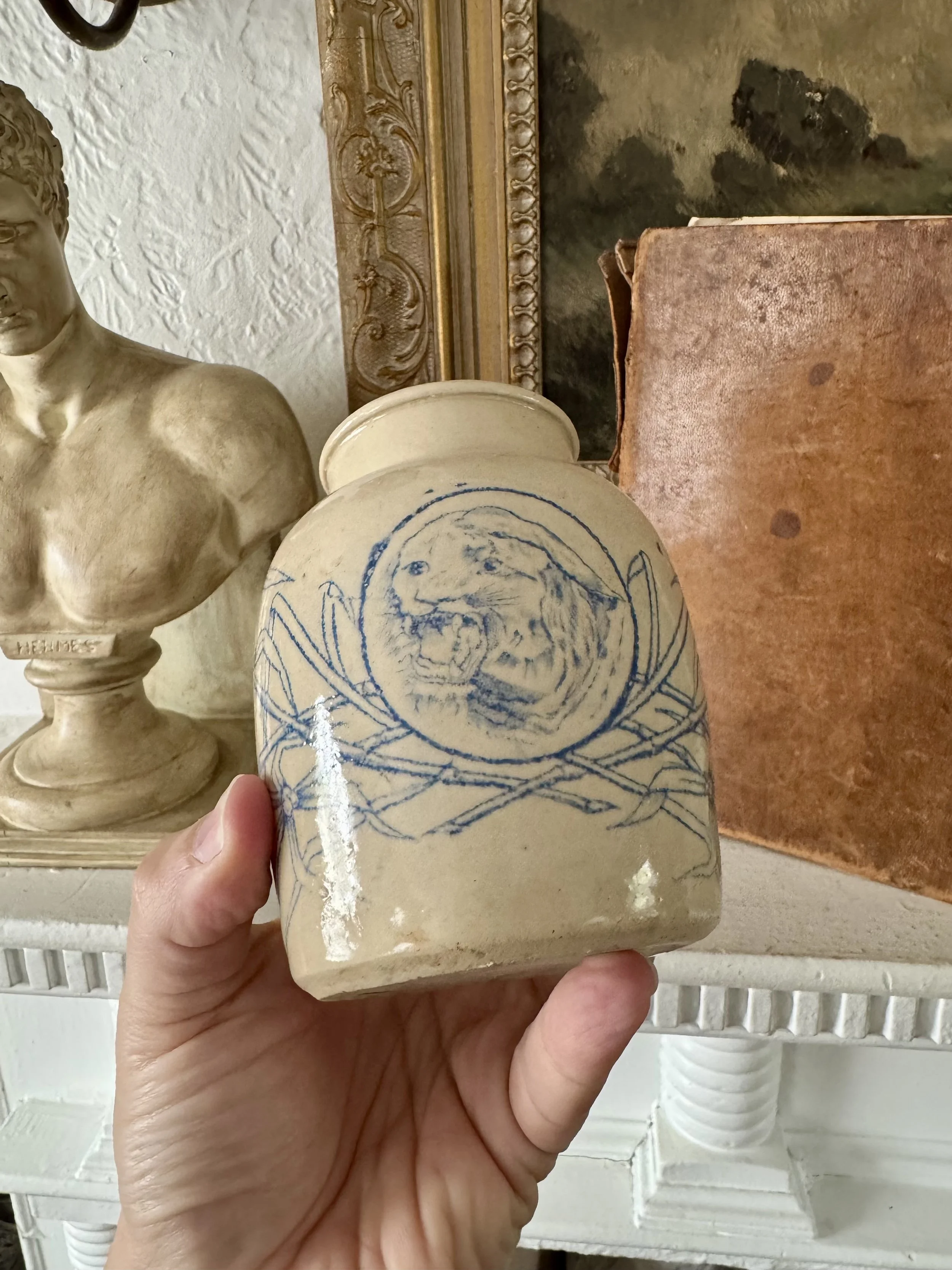 antique crock pot with jaguar portrait