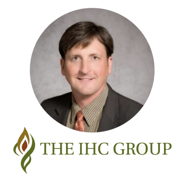 Portrait of a man in a suit with "THE IHC GROUP" logo below.