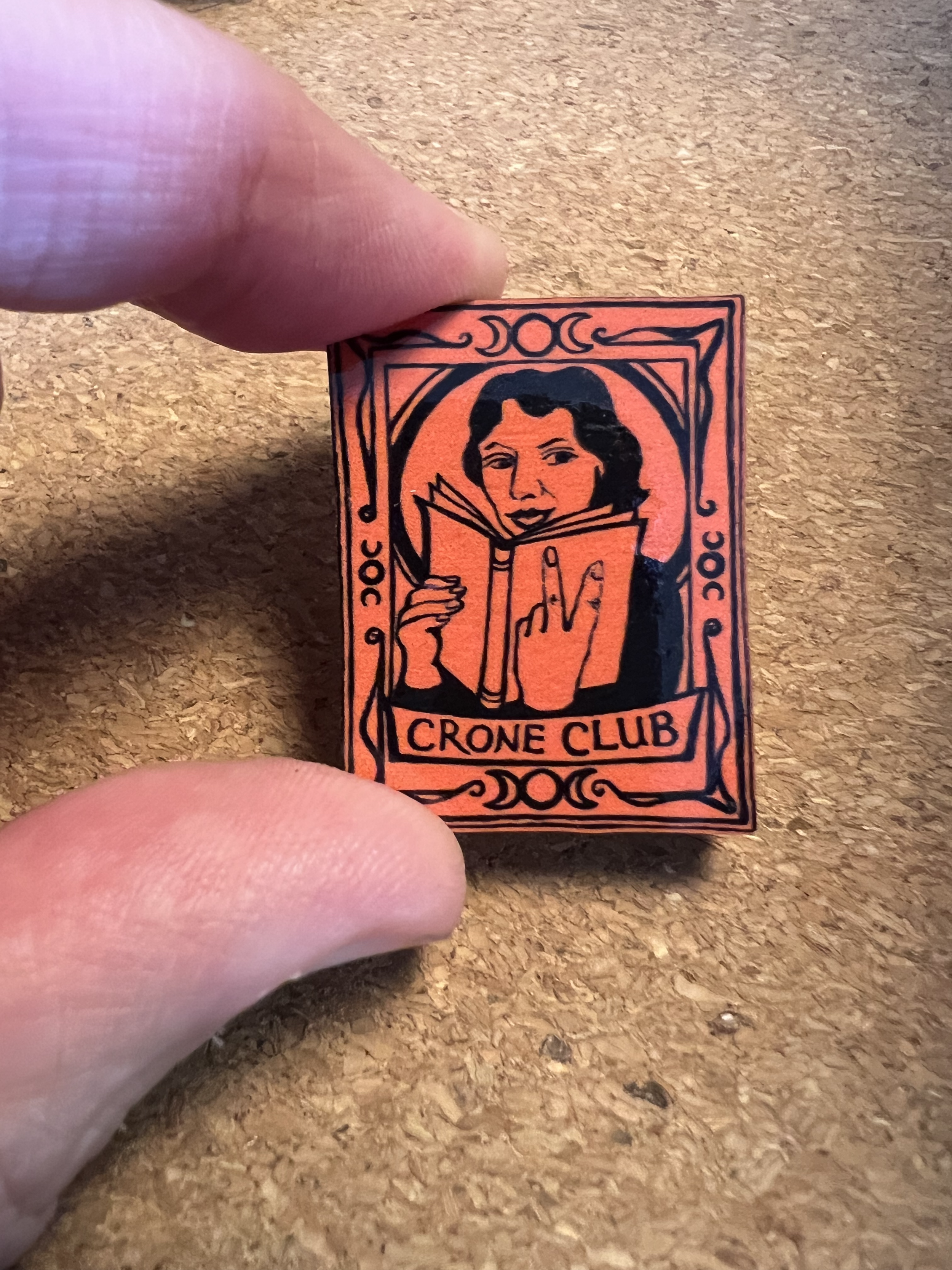 Crone Club Membership Pin Badge on Orange Cherry back gold clasp.png